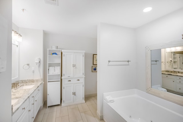 bathroom with vanity, a relaxing tiled tub, and tile patterned floors