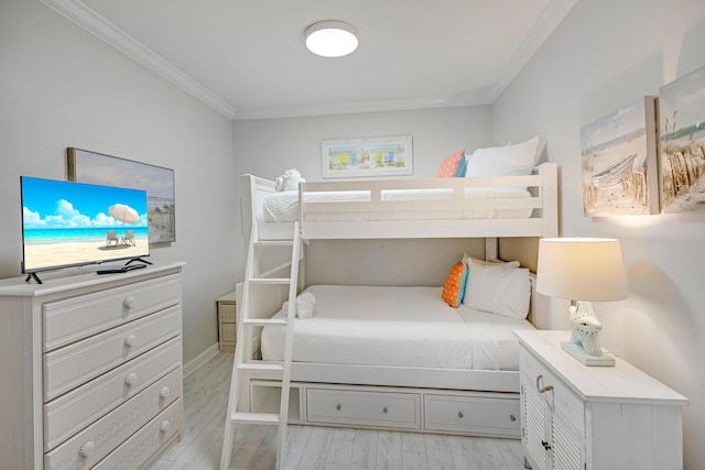 bedroom with crown molding and light hardwood / wood-style flooring