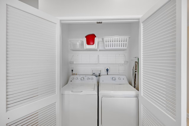 clothes washing area featuring independent washer and dryer