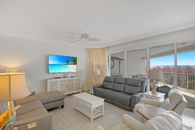 living room featuring light hardwood / wood-style flooring, ornamental molding, and ceiling fan