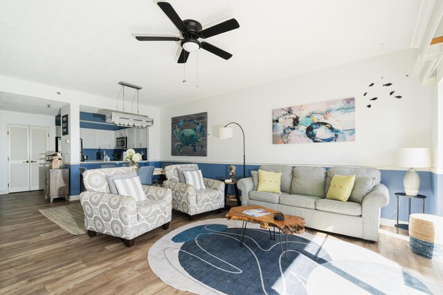 living room with ceiling fan and hardwood / wood-style floors