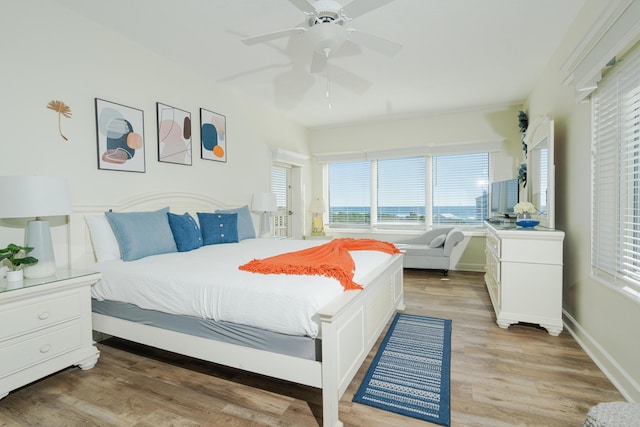 bedroom with ceiling fan and light hardwood / wood-style floors