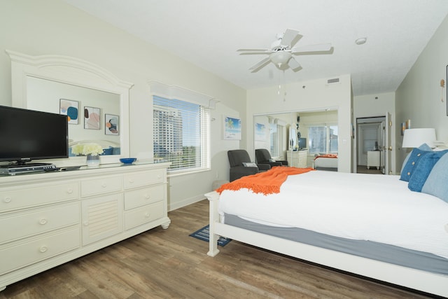 bedroom with ceiling fan, hardwood / wood-style flooring, and a closet