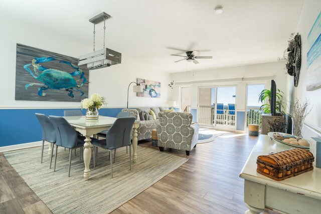 dining area featuring hardwood / wood-style flooring and ceiling fan