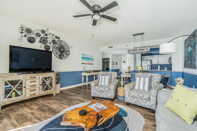 living room with hardwood / wood-style floors and ceiling fan