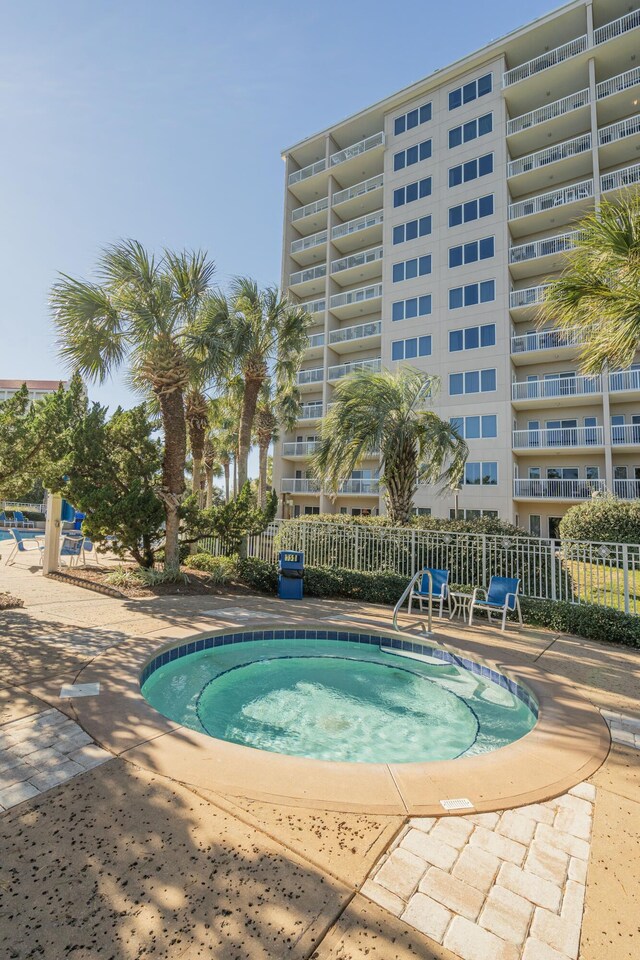 view of swimming pool featuring a hot tub