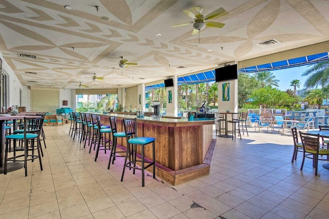 interior space featuring light tile patterned flooring and ceiling fan