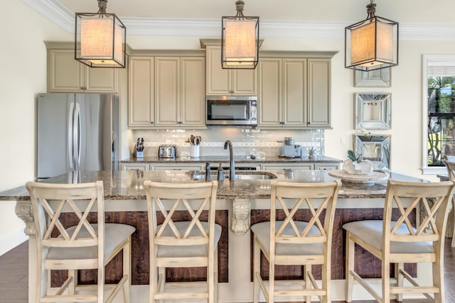 kitchen with a kitchen island with sink, sink, backsplash, and appliances with stainless steel finishes