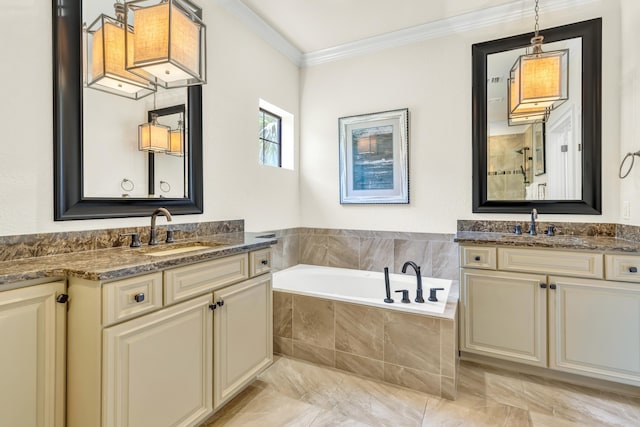 bathroom with tiled tub, vanity, and crown molding