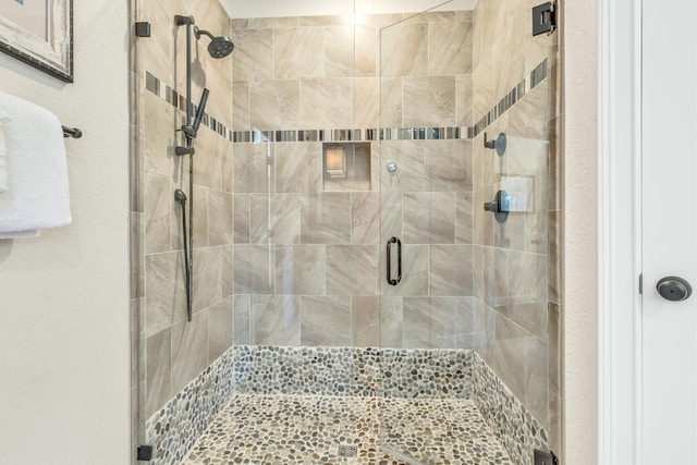 bathroom with a shower with shower door