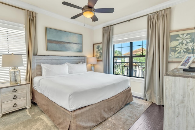 bedroom with hardwood / wood-style flooring, ceiling fan, and ornamental molding