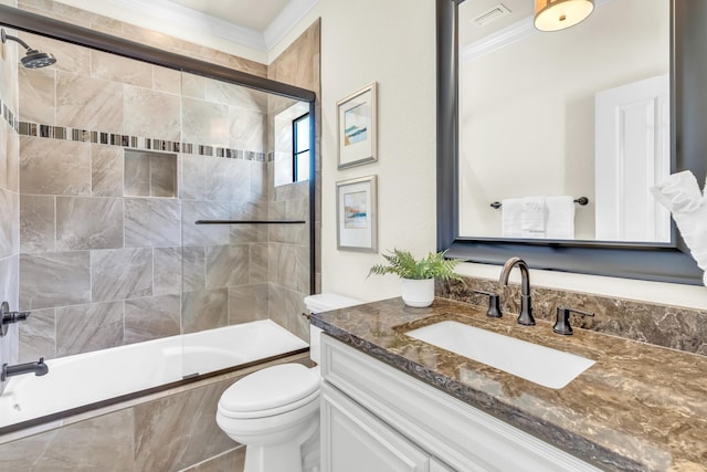 full bathroom featuring vanity, crown molding, bath / shower combo with glass door, and toilet