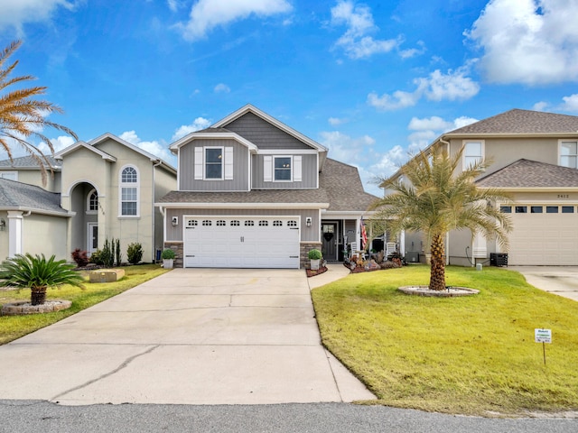 view of property featuring central AC unit, a garage, and a front lawn