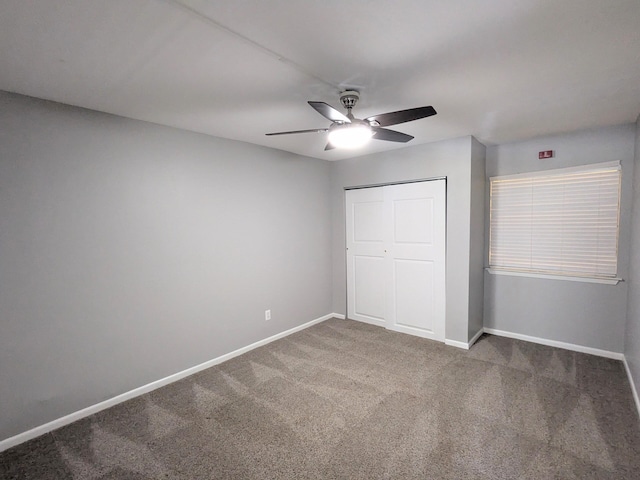 unfurnished bedroom featuring ceiling fan, a closet, and carpet flooring