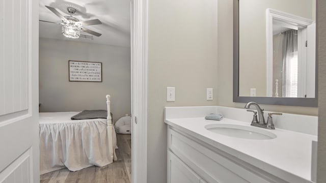 bathroom with hardwood / wood-style flooring, ceiling fan, and vanity