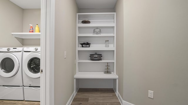 clothes washing area featuring hardwood / wood-style flooring and separate washer and dryer