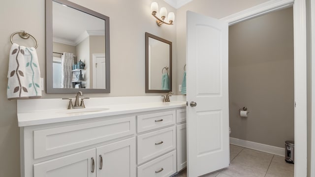 bathroom with tile patterned flooring, ornamental molding, and vanity