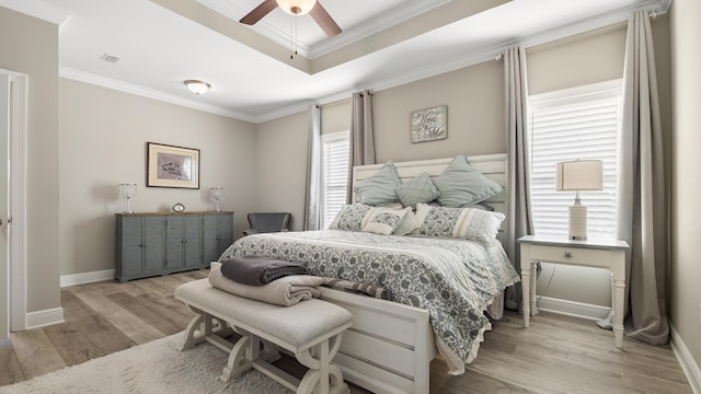 bedroom featuring crown molding, light wood-type flooring, and ceiling fan