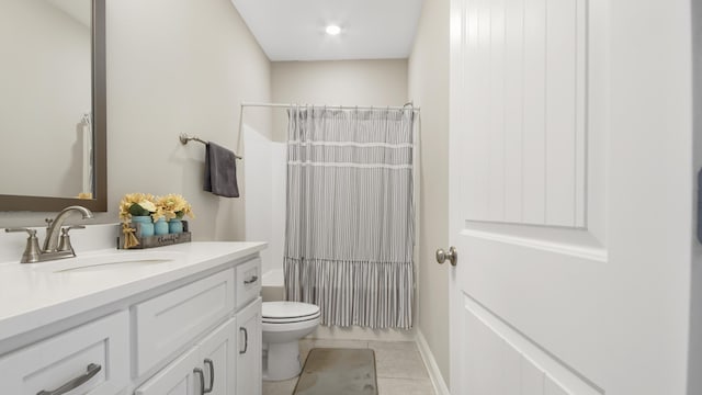 full bathroom featuring vanity, tile patterned floors, shower / bath combo with shower curtain, and toilet