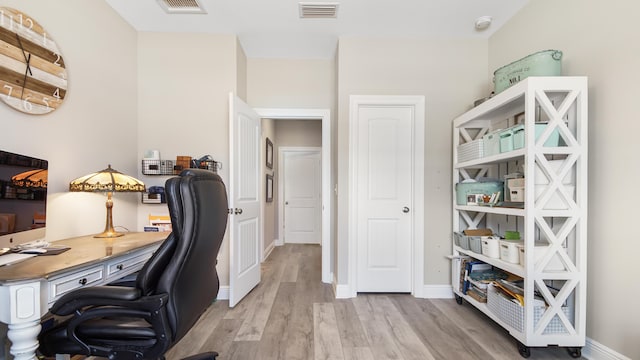 office with light wood-type flooring