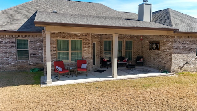 rear view of house with a patio and a lawn