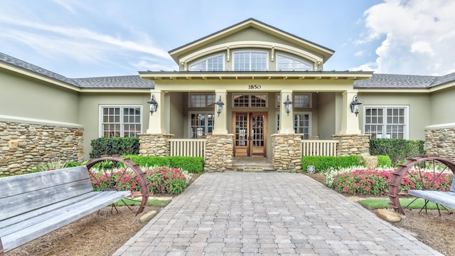 exterior space with french doors and a porch