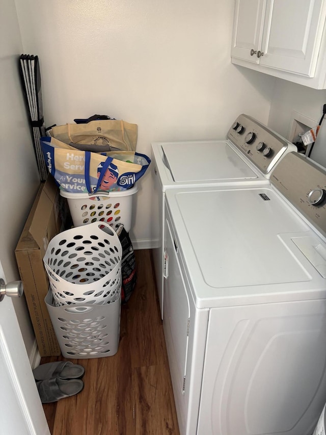 clothes washing area with cabinets, dark hardwood / wood-style floors, and independent washer and dryer