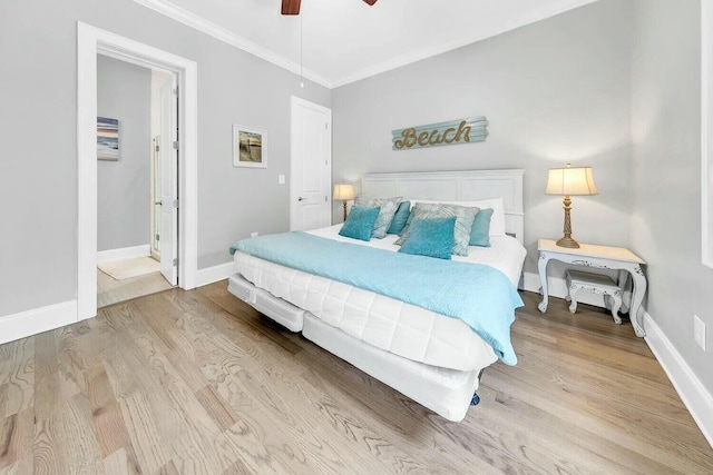 bedroom with crown molding, ceiling fan, and light hardwood / wood-style flooring