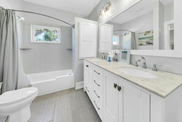 full bathroom with vanity, shower / bath combination with curtain, and toilet