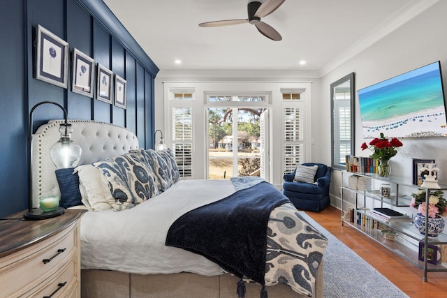 bedroom with hardwood / wood-style floors, crown molding, and ceiling fan