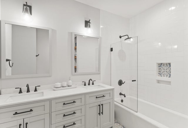 bathroom featuring tiled shower / bath combo and vanity