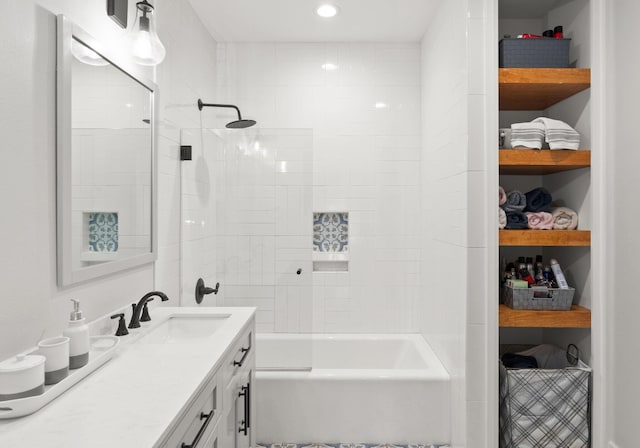 bathroom featuring tiled shower / bath combo and vanity