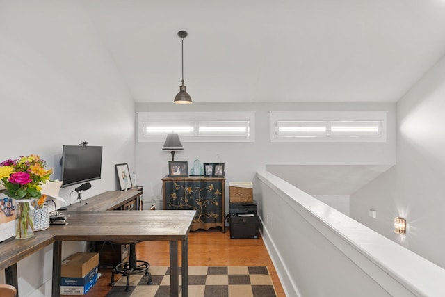 home office with lofted ceiling and light hardwood / wood-style floors