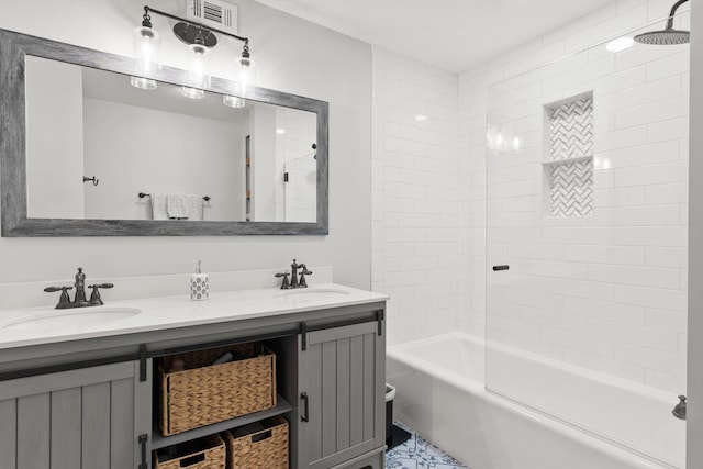 bathroom with tiled shower / bath and vanity