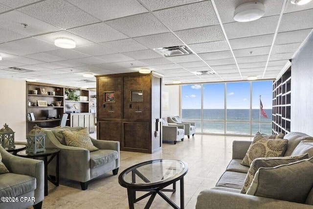 living room with a wall of windows and a water view