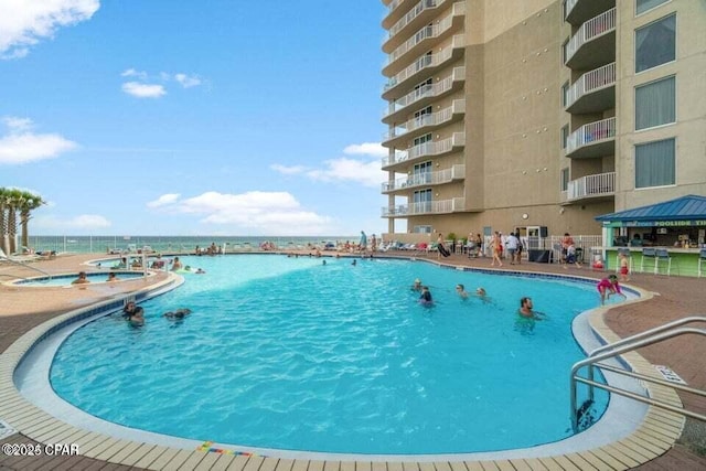 view of swimming pool featuring a gazebo and a water view