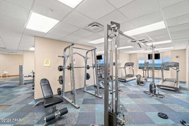 gym with a paneled ceiling