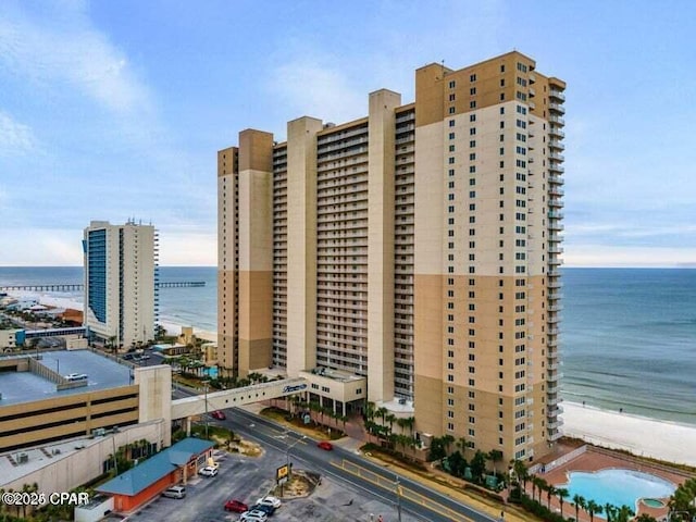 view of property featuring a water view and a view of the beach