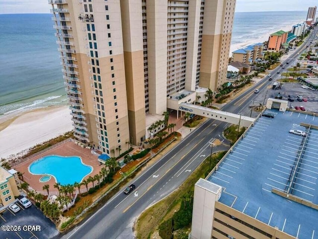 aerial view with a water view and a view of the beach