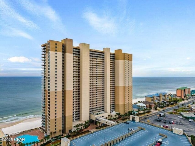 view of property featuring a water view and a beach view