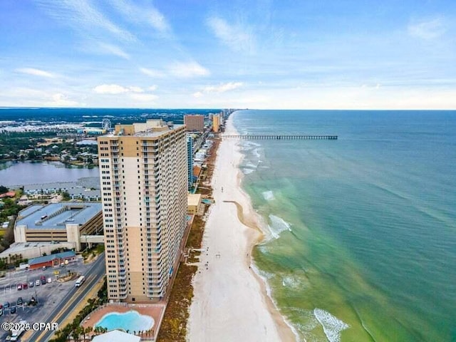 birds eye view of property with a water view and a view of the beach