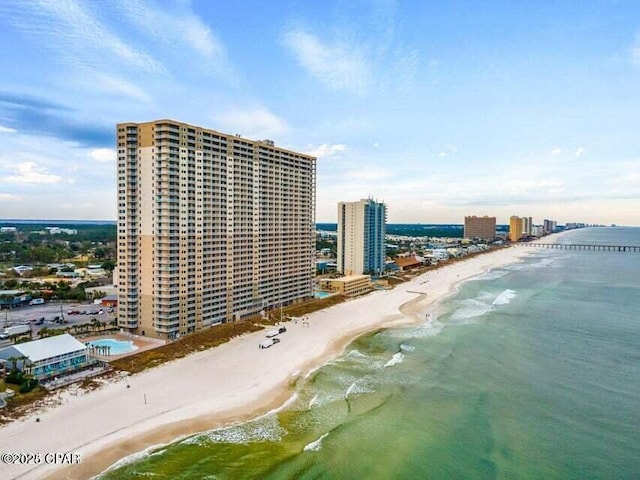 birds eye view of property with a water view and a view of the beach