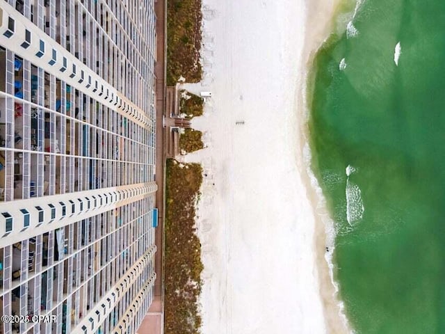 drone / aerial view with a beach view and a water view