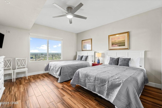 bedroom with dark hardwood / wood-style floors and ceiling fan