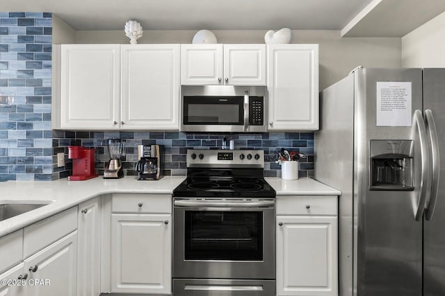 kitchen featuring backsplash, stainless steel appliances, and white cabinets