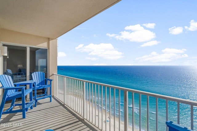 balcony featuring a water view and a beach view