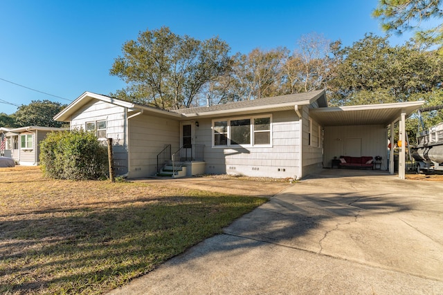 view of front of house with a front yard and a carport