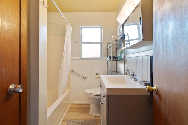 full bathroom with vanity, hardwood / wood-style floors, shower / bath combo with shower curtain, and toilet