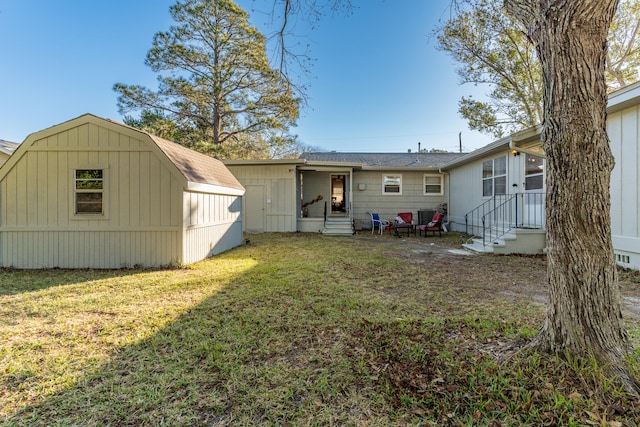 rear view of property with a lawn