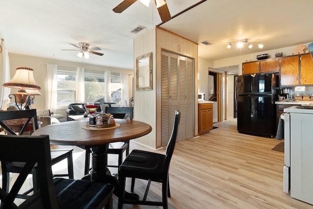 dining room with ceiling fan and light hardwood / wood-style floors